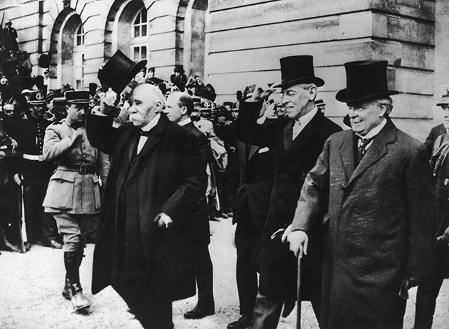 Clemenceau (left), Wilson (center), and Lloyd George (right) at Versailles (Photo by Hulton Archive/Getty Images)